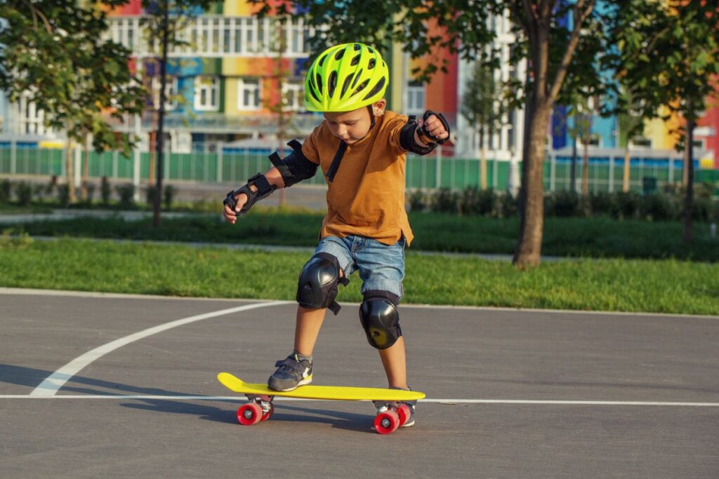 child learning how to skateboard on a penny board