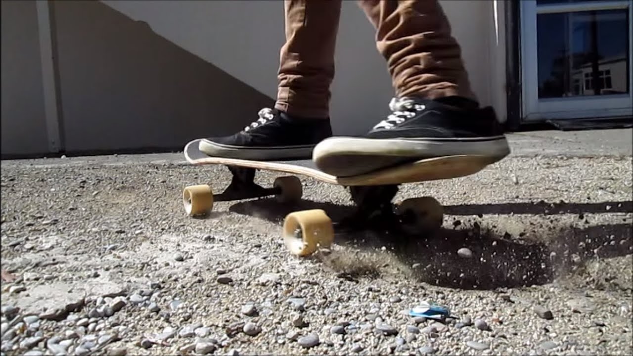 skateboard with longboard wheels riding on gravel