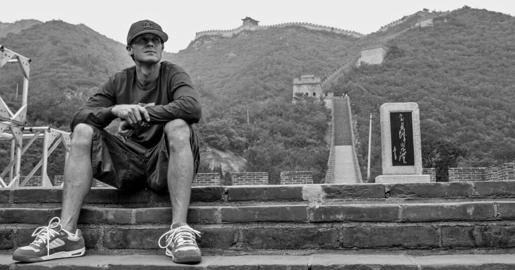 Danny Way sitting on steps of the Great Wall of China